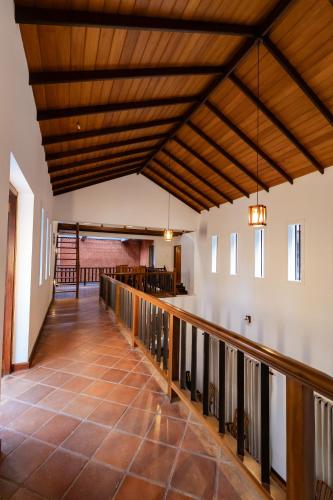 a large hallway with a wooden ceiling and a balcony at Ceylon Holiday Homes in Kandy