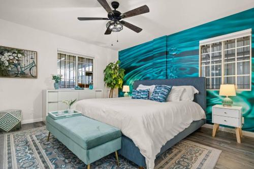 a bedroom with a large bed with a blue accent wall at LA Group Stay Sleeps 10 ParkingNear SoFiLAX in Los Angeles