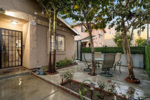 a patio with a table and chairs and trees at LA Group Stay Sleeps 10 ParkingNear SoFiLAX in Los Angeles