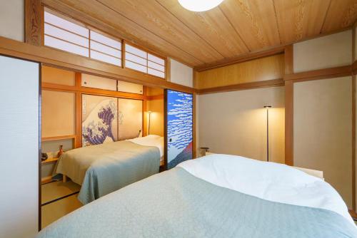 a bedroom with two beds and a window at Oc4 お花茶屋駅から4分の戸建て in Tokyo