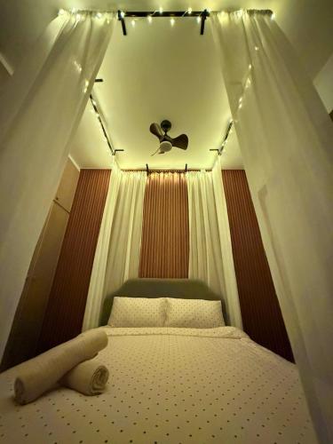 a bedroom with a canopy bed with a ceiling at The Almost Touching the Stars Suite in Genting Highlands