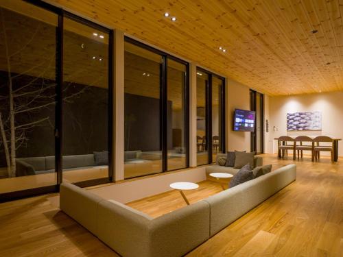 a living room with a couch and a table at Rakuten STAY VILLA Aso Kurokawa -103 1LDK Capacity of 6 persons in Minamioguni