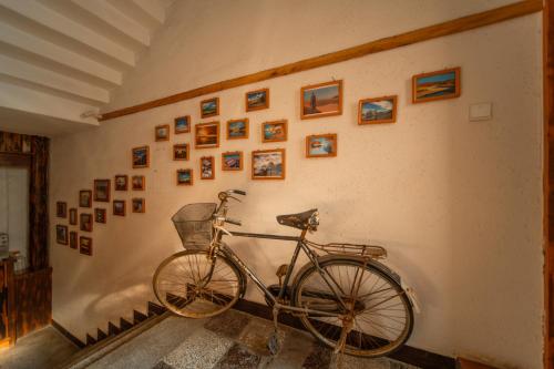 a bike parked against a wall with pictures on it at Zhangjiajie Wangyi Inn in Zhangjiajie