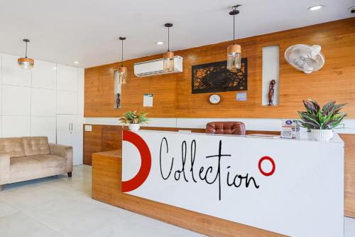 a lobby with a counter with a colgate sign at Hotel O Tree Inn in Zirakpur