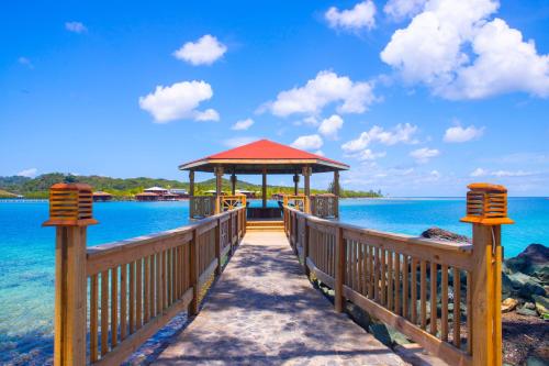 a wooden pier with a gazebo on the water at Fantasy Island Beach Resort and Marina - All Inclusive in First Bight