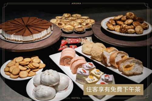 a table filled with different types of food on plates at Arsma Hotel in Hualien City