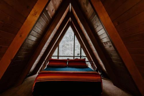 a bed in a room with a window at Idyllcreek From Sunset Mag - Hottubwalk To Town! in Idyllwild