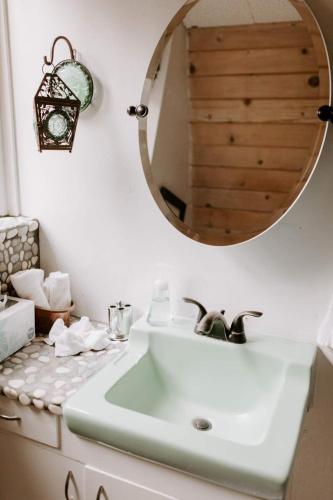 a bathroom with a sink and a mirror at Idyllcreek From Sunset Mag - Hottubwalk To Town! in Idyllwild