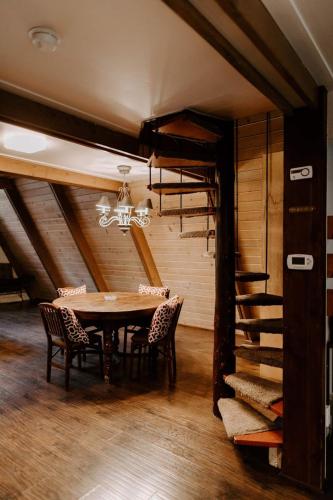 a dining room with a table and chairs and a loft at Idyllcreek From Sunset Mag - Hottubwalk To Town! in Idyllwild