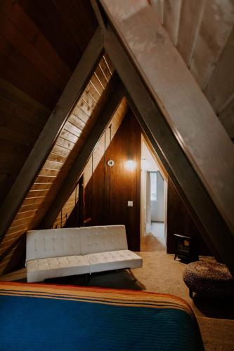 a living room with a couch in the attic at Idyllcreek From Sunset Mag - Hottubwalk To Town! in Idyllwild