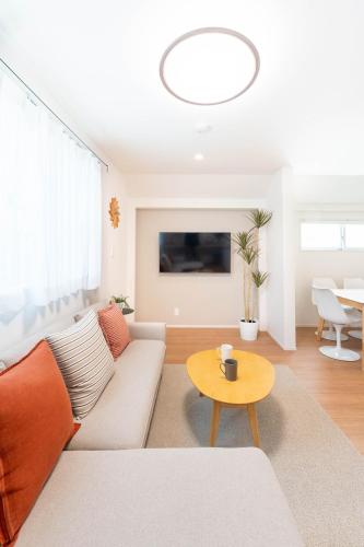 a living room with a couch and a table at 千尋 130t in Tokyo