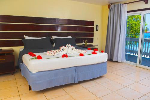 a bedroom with a large bed with flowers on it at Fantasy Island Beach Resort and Marina - All Inclusive in First Bight