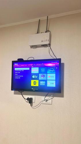 a flat screen tv hanging on a wall at Pacific Apartamento Surco in Lima