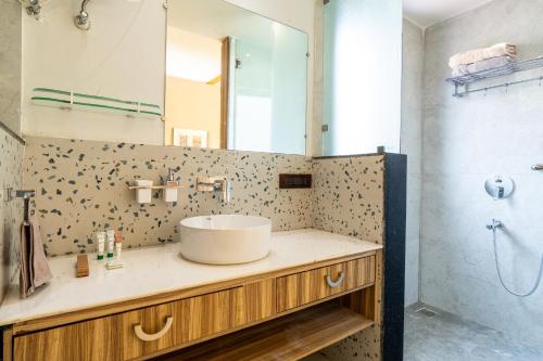 a bathroom with a sink and a mirror at SaffronStays Sukh Saklana Haveli Royalty in Dehradun