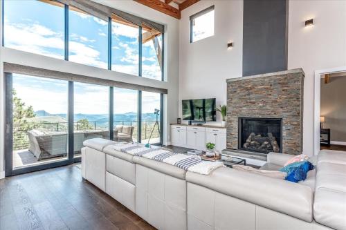 a living room with a large couch and a fireplace at Mountain Cabin W Deck Views & Hot Tub in Bailey