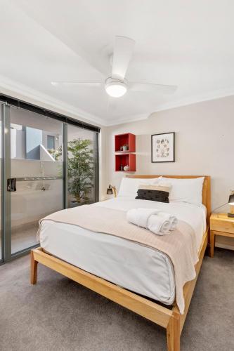 a bedroom with a large bed and a large window at 2 Royal Rest Quality 2BR West Perth-parking in Perth