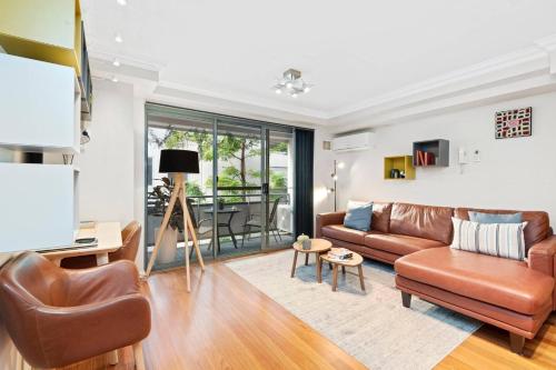 a living room with a couch and a table at 2 Royal Rest Quality 2BR West Perth-parking in Perth