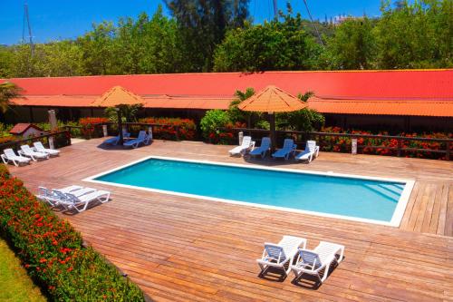 a swimming pool with chairs and umbrellas next to at Fantasy Island Beach Resort and Marina - All Inclusive in First Bight