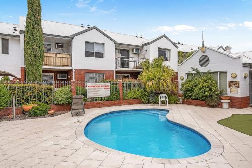 a house with a swimming pool in a yard at 6 Light Bright Home in South Perth in Perth