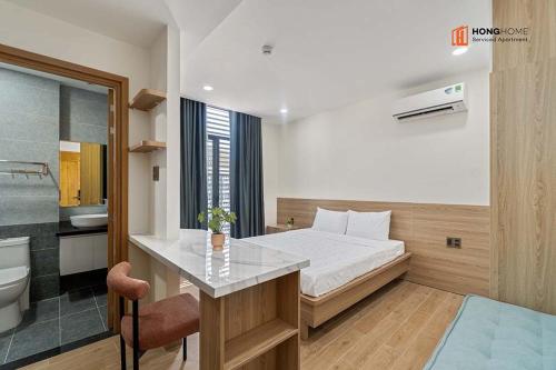 a hotel room with a bed and a bathroom at HongHome Nguyễn Cửu Vân in Ho Chi Minh City
