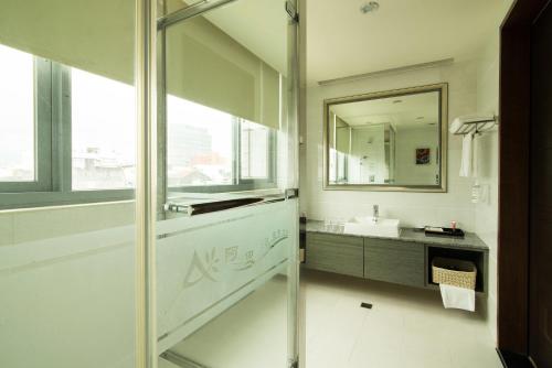 a bathroom with a sink and a mirror at Arsma Hotel in Hualien City