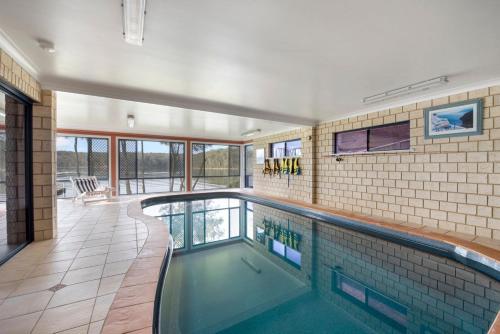 a swimming pool in a house at The Lake House - lakeside retreat w. pool & views in Burrill Lake