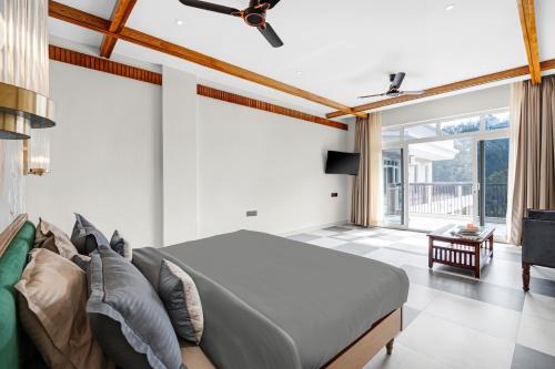 a bedroom with a large bed and a couch at SaffronStays Sukh Saklana Haveli Royalty in Dehradun