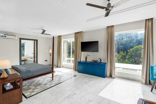 a bedroom with a bed and a flat screen tv at SaffronStays Sukh Saklana Haveli Royalty in Dehradun