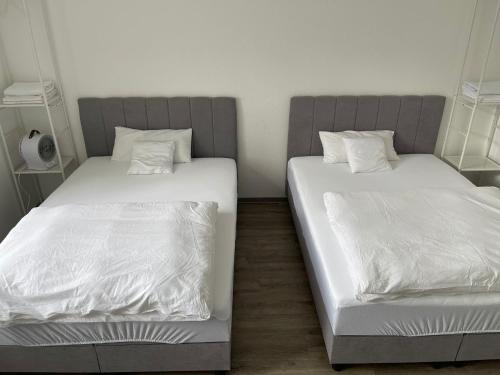 two beds sitting next to each other in a room at 2-4 People in Peaceful Room Kassel city in Kassel