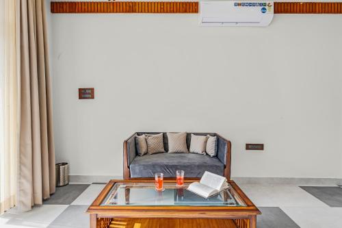 a living room with a couch and a glass table at SaffronStays Sukh Saklana Haveli Royalty in Dehradun