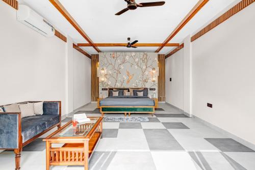 a living room with a couch and a bed at SaffronStays Sukh Saklana Haveli Royalty in Dehradun