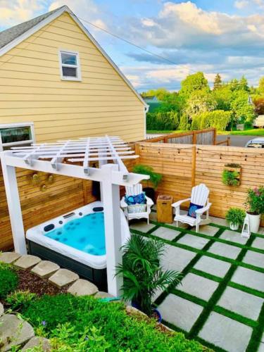 a backyard pool with a hot tub and a pergola at Private Basement Suite w Hot Tub in Camas