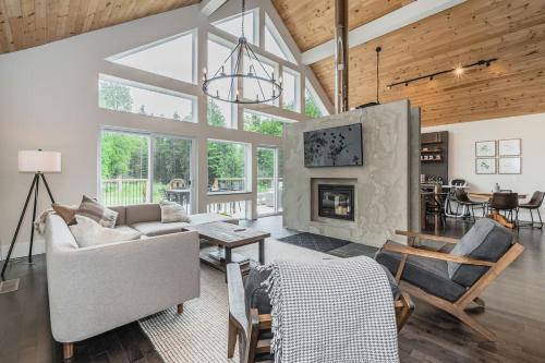 a living room with a couch and a fireplace at Luxury Tobermory Retreat Modern Home and Hot Tub in Tobermory