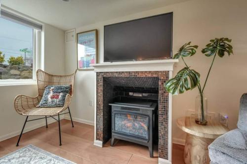 a living room with a fireplace with a flat screen tv above it at Private Basement Suite w Hot Tub in Camas