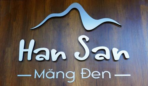 a close up of a haram sign on a wooden table at Han San Homestay Măng Đen in Kon Plong