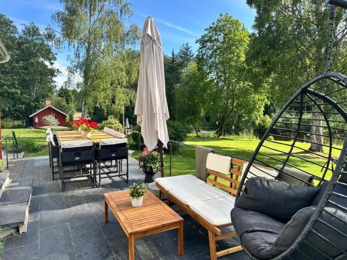 a patio with a table and an umbrella at Prästgården in Norberg