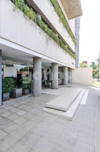 an external view of a building with columns and plants at Comfy Villa Morra Apt in Asuncion