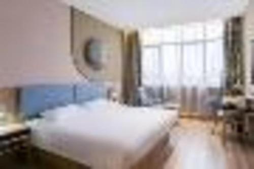 a bedroom with a bed and a large window at Home Inn Neo Zhuji Zhejiang Agriculture and Forestry University in Shaoxing
