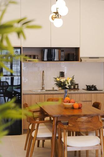 a kitchen with a wooden table with a bowl of fruit on it at GOtoBED in Mutiara Airport
