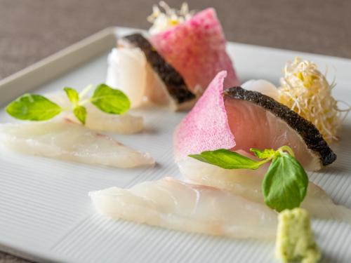 a plate with four different types of food on it at KAMENOI HOTEL Ome in Ome