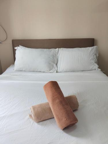 a white bed with two towels on it at Simple Stay Perfect for Restful Nights in Molo