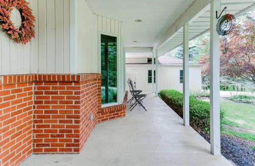 a porch of a house with a brick wall at The Textile House 5 Miles To Umich! in Ypsilanti
