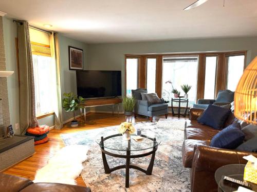 a living room with a couch and a table at The Textile House 5 Miles To Umich! in Ypsilanti