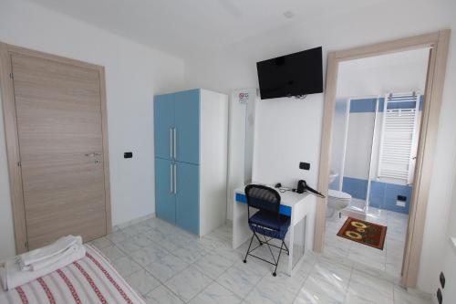 a bedroom with a desk and a chair in a room at Ciro BED AND BREAKFAST la villetta in Pioltello