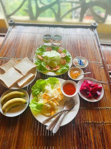 a table with plates of food on a table at Eco Farmer House - Sapa Retreat in Sa Pa