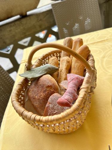 a basket filled with different types of bread on a table at Valtellinda in Bianzone