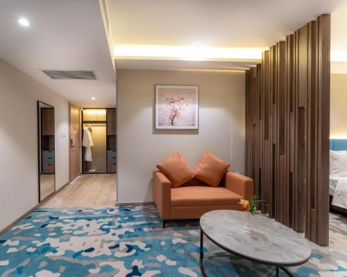 a living room with a couch and a table at The Skye Phnom Penh Hotel & Apartments in Phnom Penh