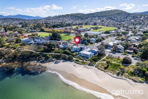 an aerial view of a beach next to the ocean at The Cambridge in Warrane