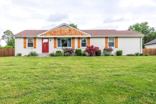a house with a green lawn in front of it at Oasis Of Nashville, With A Pool And Hot Tub ! in Nashville