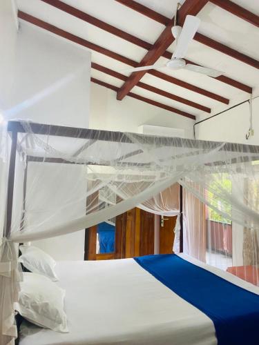 a bedroom with two bunk beds and a ceiling at Heaven Of Hikka in Hikkaduwa